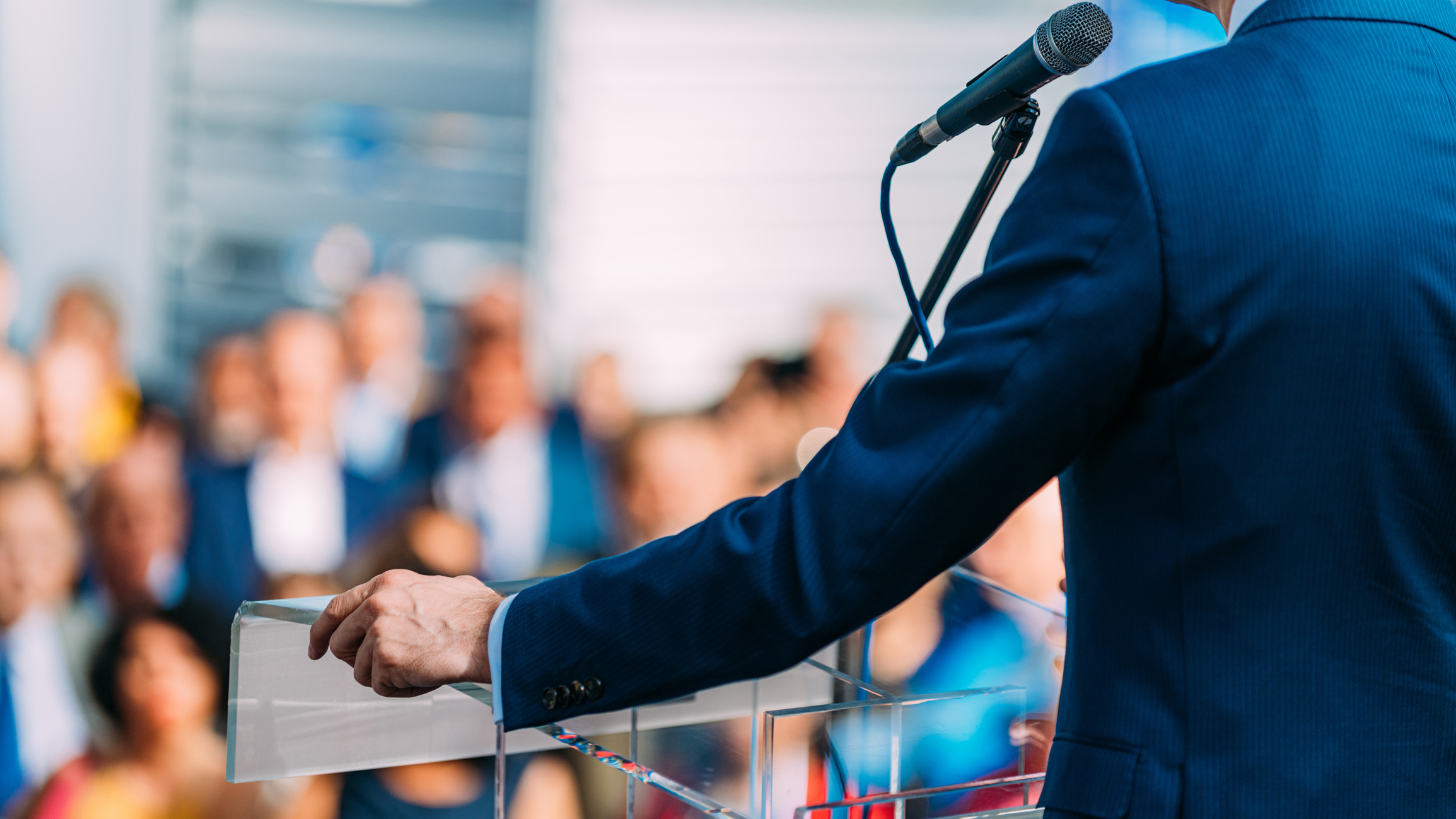 Leader speaking before a large audience