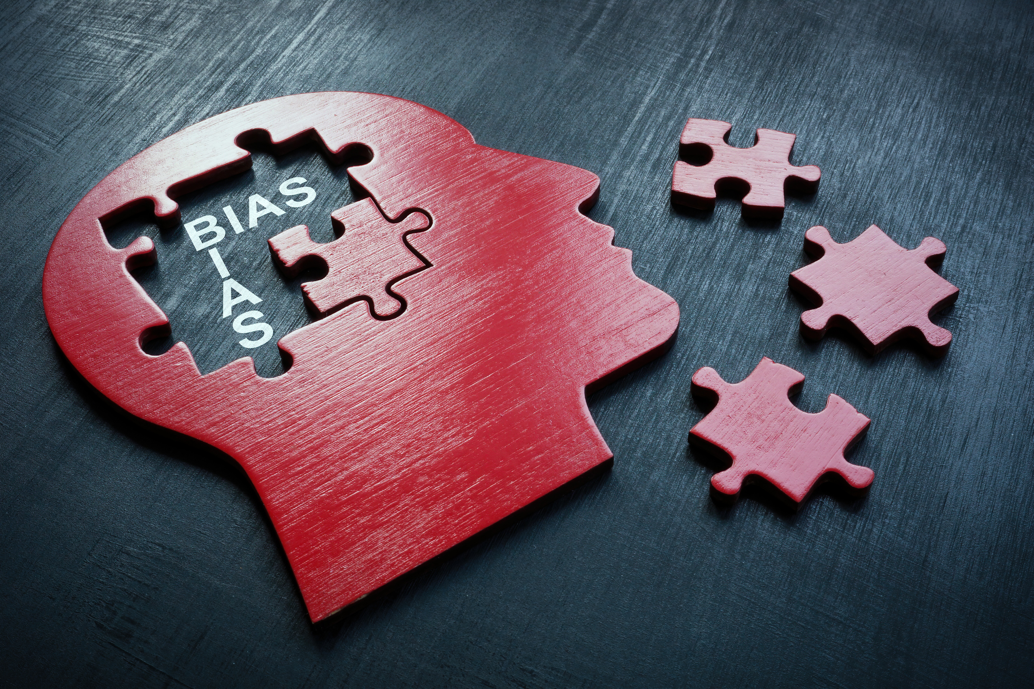 Head with puzzle pieces and the text, "bias"